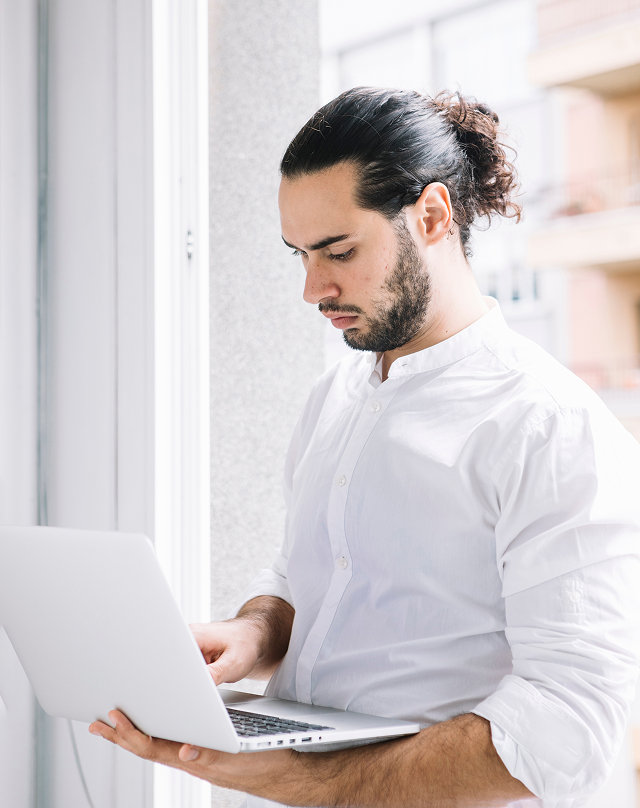 a man standing with a computer